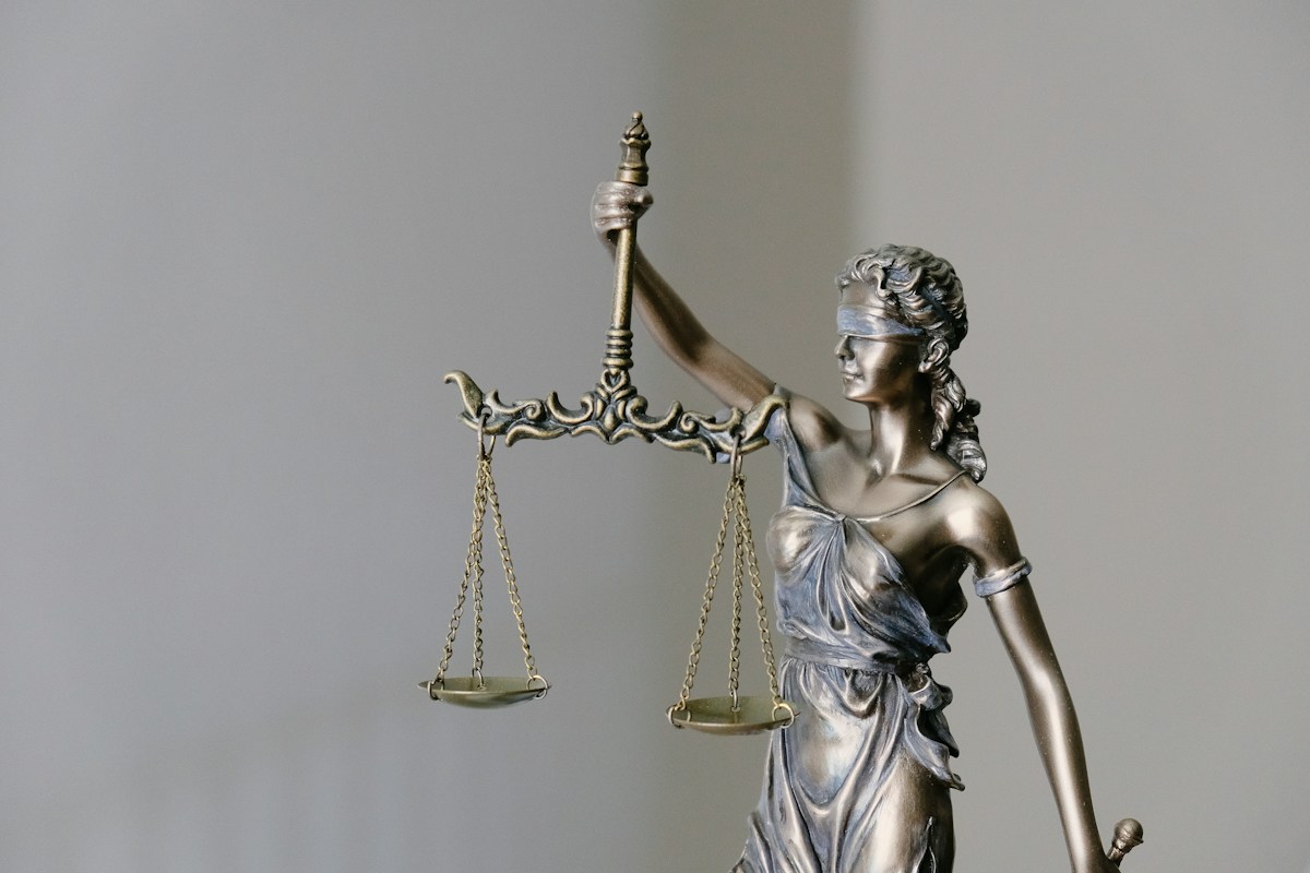 Lady Justice statue symbolizing legal sources and regulatory research